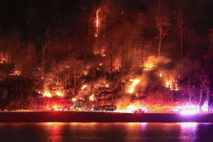 First responders arrive at an area burning by the Jennings Creek Wildfire on Nov. 13, 2024 in Greenwood Lake, New York. An extended drought has helped fuel the Jennings Creek Wildfire on the New York-New Jersey border, which has grown to 5,000 acres across both states.