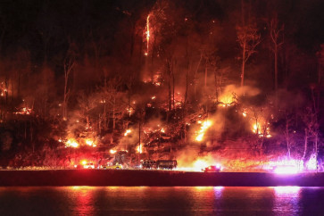 First responders arrive at an area burning by the Jennings Creek Wildfire on Nov. 13, 2024 in Greenwood Lake, New York. An extended drought has helped fuel the Jennings Creek Wildfire on the New York-New Jersey border, which has grown to 5,000 acres across both states.