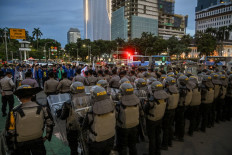 Riot police stand guard as students protest against the government's decision to increase the value-added tax (VAT) from 11 percent to 12 percent, effective from the beginning of 2025, in Jakarta on Dec. 26, 2024.