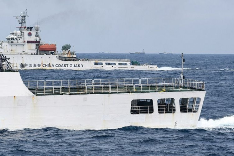 A Chinese coast guard vessel draws alongside Indonesian Navy ship KRI Usman Harun as the latter moves to intercept Chinese fishing boats in Indonesia's exclusive economic zone (EEZ) in the North Natuna Sea on Nov. 1, 2020.