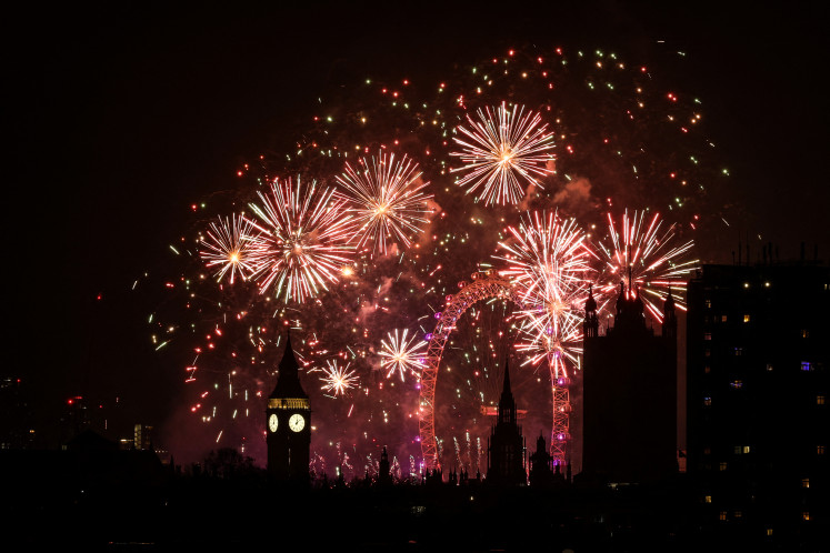 Fireworks explode in the sky around the London Eye and The Elizabeth Tower, commonly known by the name of the clock's bell, “Big Ben“, at the Palace of Westminster, home to the Houses of Parliament, in central London, just after midnight on Jan. 1, 2025.