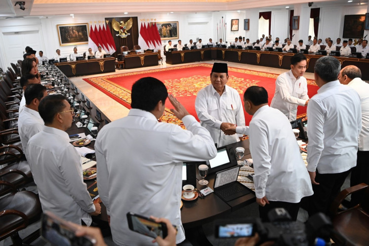 President Prabowo Subianto (center) and Vice President Gibran Rakabuming Raka (third right) greet Red and White Cabinet ministers on Dec. 2, 2024, before a plenary cabinet meeting at the Presidential Palace in Jakarta. 