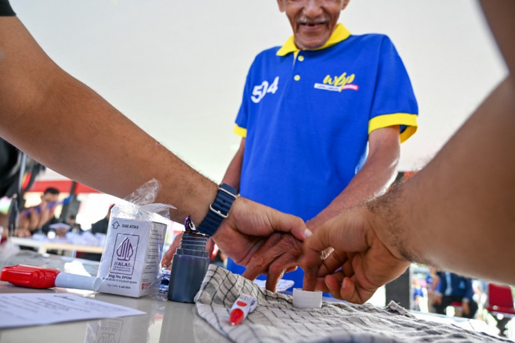 Democracy in action: An inmate has his finger inked after casting his ballot for the 2024 presidential and legislative elections on Feb. 14, 2024, at a polling station in a prison in Banda Aceh, Aceh.