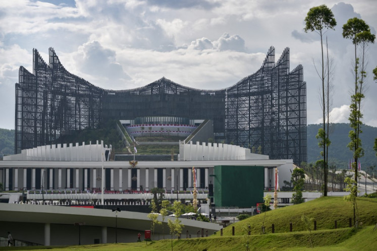 The wing-shaped skeleton frame of Garuda Palace reaches out beneath white clouds on Aug. 17, 2024, during the 79th Independence Day celebrations in Nusantara, East Kalimantan.
