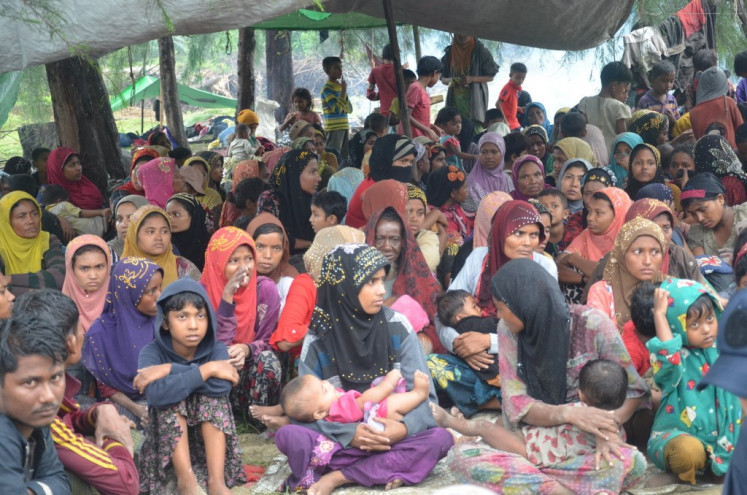Some 264 newly-arrived Rohingya refugees gather to be registered on Jan. 6 after landing by boat on the beach of Kuala Seumilang Alue Bu in East Aceh, Indonesia.
