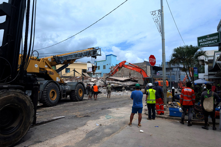 Critical assistance: Rescue workers are seen at the site of a collapsed building after an earthquake struck Port Vila, the capital city of Vanuatu, on Dec. 18, 2024.