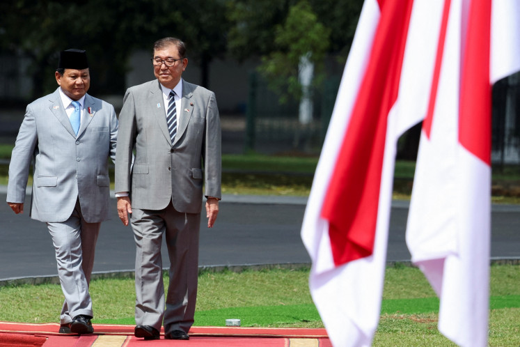 Indonesia's President Prabowo Subianto (R) and Japan's Prime Minister Shigeru Ishiba inspect the guard of honour at the presidential palace in Bogor, West Java, on  Monday, January 11, 2025.