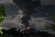 This handout picture taken and released on January 11, 2025 by Indonesian Geological Agency shows Mount Ibu spewing volcanic material approximately 4,000 meters high during an eruption as observed from the Mount Ibu Volcano Observation Post in West Halmahera, North Maluku on January 11, 2025. 