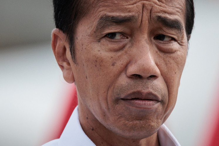 Former president Joko 'Jokowi' Widodo speaks with the media after the departure ceremony of the National Disaster Management Agency's (BNPB) mission to deliver humanitarian aid, 60 tonnes of medical and hygiene supplies on two planes, to Egypt for Palestinian refugees and Sudan at Halim Perdanakusuma International Airport in Jakarta on April 3, 2024. 