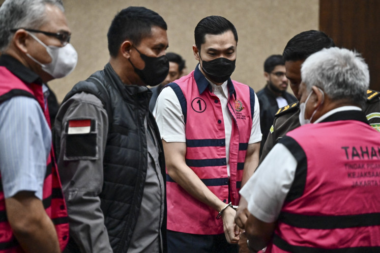 Defendants in the corruption case pertaining to state-owned tin miner PT Timah, Harvey Moeis (center), Suparta (right) and Reza Andriansyah (left) walk out of the courtroom after a verdict hearing in the Jakarta Corruption Court on Dec. 23, 2024. 
