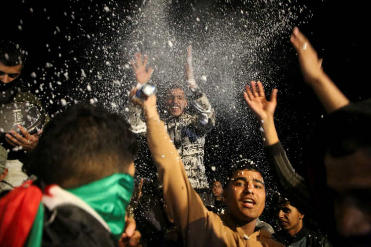  Palestinians react to news on a ceasefire deal with Israel, in Khan Younis in the southern Gaza Strip, on Wednesday, January 15, 2025. 