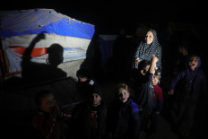Palestinians celebrate at their camp for people displaced by conflict at Deir el-Balah in the central Gaza Strip, on Jan. 15, 2025, amid the ongoing war in the Palestinian territory between Israel and Hamas.