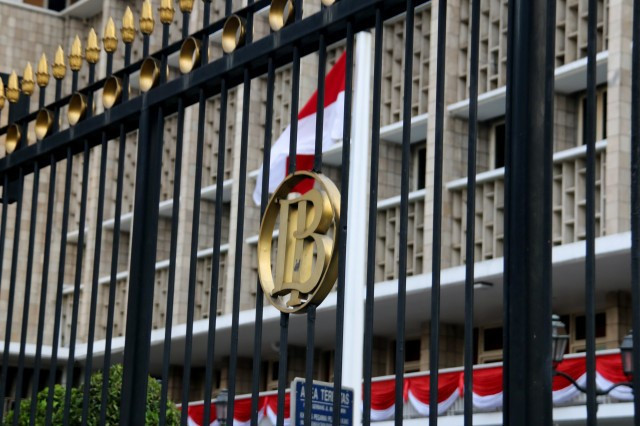 The national flag flies at full-mast behind a fence bearing the Bank Indonesia logo at the central bank’s headquarters in Central Jakarta, in this undated photo.