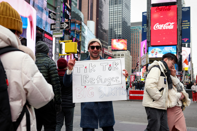 A social media influencer films a video for his new Xiaohongshu, also known as RedNote, after leaving TikTok in Times Square in New York City, the United States, on Jan. 16, 2025.