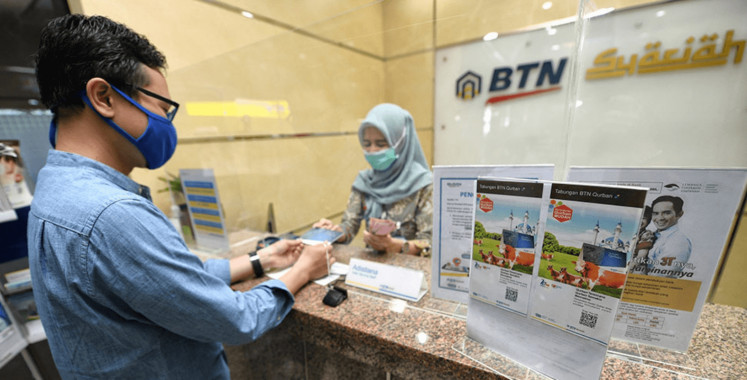 A customer conducts a transaction at a BTN Syariah branch in this undated photo.