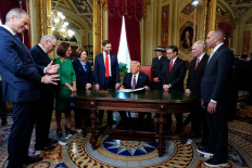 US President Donald Trump takes part in a signing ceremony in the President's Room following the inauguration ceremony at the US Capitol on January 20, 2025, in Washington, DC. Also pictured (left to right), Senate Majority Leader Sen. John Thune, Senate Minority Leader Sen. Chuck Schumer, Senator Deb Fischer, Sen. Amy Klobuchar, Vice President JD Vance, Melania Trump, House Speaker Mike Johnson, House Majority Leader Steve Scalise and House Minority Leader Hakeem Jeffries.