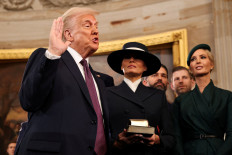 US President-elect Donald Trump takes the oath of office as Melania Trump, Ivanka Trump, Donald Trump Jr. and Eric Trump look on during inauguration ceremonies in the Rotunda of the US Capitol on Monday, January 20, 2025 in Washington, DC. Donald Trump takes office for his second term as the 47th president of the United States. 