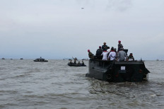 A flotilla of boats with Indonesian Navy personnel on board travels to take down a mysterious sea fence in Tangerang, Banten, on Jan. 23, 2025.