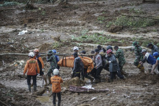 Rescue teams, including the National Search and Rescue Agency (Basarnas), the Army, police and volunteers, use high-pressure water to search for victims of a landslide triggered by heavy rain that claimed 19 lives, in Kasimpar Village, Central Java, on Jan. 22, 2025. 