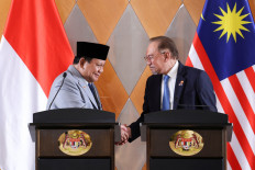 President Prabowo Subianto and Malaysian Prime Minister Anwar Ibrahim shake hands on Jan. 27, 2025, before addressing a joint press conference in Kuala Lumpur.