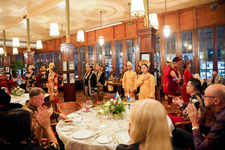 Restaurant staff in traditional dress representing Indonesia's diverse culture welcome guests at Cafe Batavia's 31st anniversary dinner on December 7, 2024.