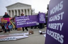 Transgender rights opponents rally outside of the US Supreme Court as the justices hear arguments in a case on transgender health rights on December 04, 2024 in Washington, DC. The Supreme Court is hearing arguments in US v. Skrmetti, a case about Tennessee's law banning gender-affirming care for minors and if it violates the Constitution's equal protection guarantee. 