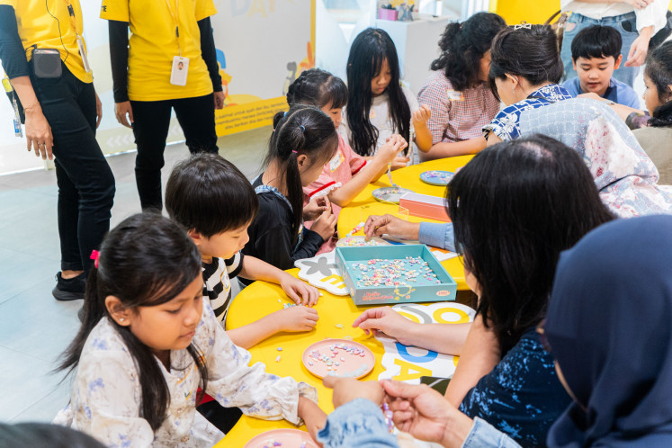 Children explore their creativity through a handicraft activity at an OH!SOME store.
