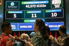People watch carbon trading activity on a digital screen at the Indonesian stock exchange building in Jakarta on January 20, 2025.