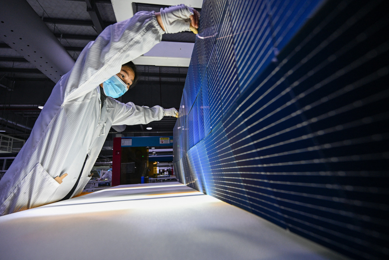 Economic driver: A worker produces photovoltaic (PV) modules for solar panels in a factory in Suqian, Jiangsu province, China, on Jan. 23, 2025.