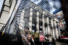 A police officer stands guard in front of the Constitutional Court building on Feb. 4, 2025, in Jakarta.