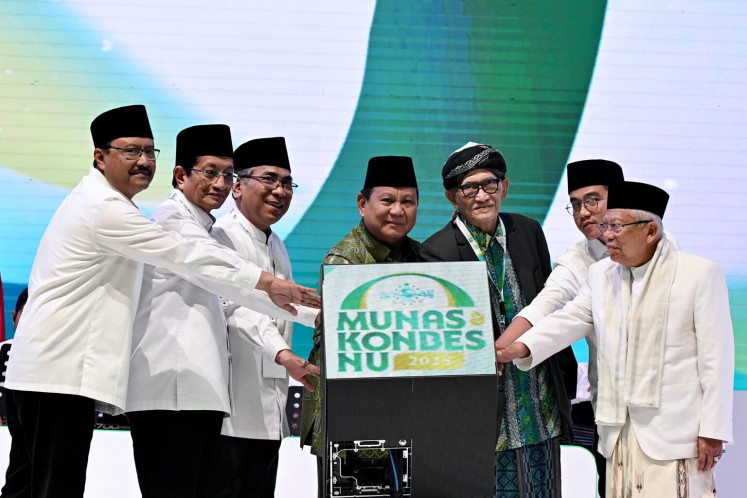 President Prabowo Subianto (center) is flanked by Nadhlatul chairman Yahya Cholil Staquf (third left) and supreme leader Miftachul Achyar (third right) during a ceremony to commemorate NU's 102nd anniversary on Feb. 5, at the Istora Indoor Stadium in Central Jakarta.