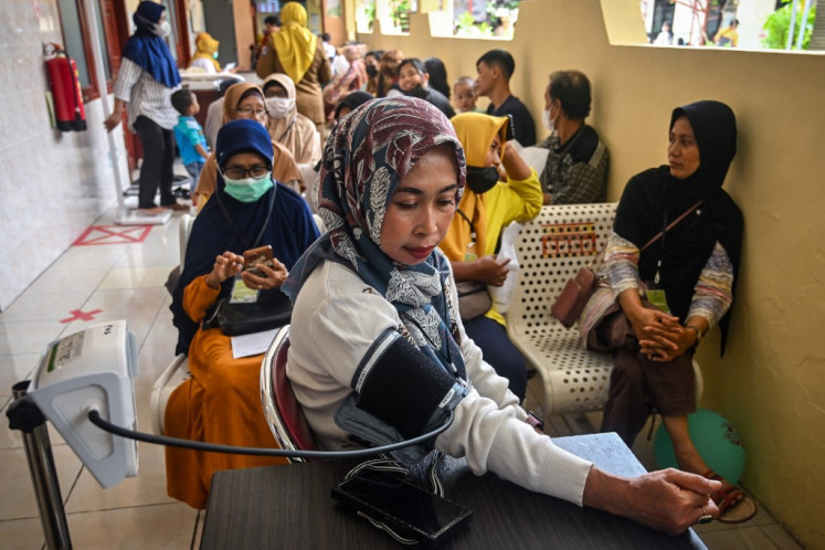 A woman is checked during the opening day of a nationwide free health check-up program at a community health center in Surabaya, East Java, on Feb. 10, 2025.