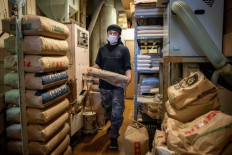 Bags of rice are seen piled up at 'Koike rice shop' in Tokyo on Feb. 14, 2025. The Japanese government said it will release its stockpile of rice, the nation's cherished staple food, reserved for emergency use in response to soaring prices.