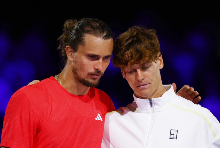 Italy's Jannik Sinner (right) embrace Germany's Alexander Zverev during the trophy ceremony after winning the final of the Australian Open at Melbourne Park in Melbourne, Australia on Jan. 26, 2025.