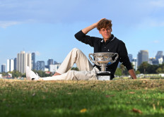 Italy's Jannik Sinner poses with the Australian Open trophy during a photo shoot session at Albert Park Lake in Melbourne, Australia on Jan. 27, 2025.
