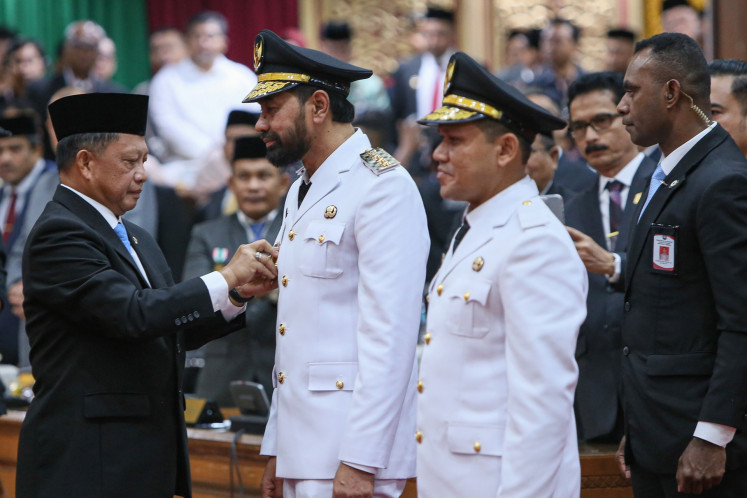 Home Minister Tito Karnavian (left) pins a badge to Aceh Governor Muzakir Manaf (second left) during the inauguration of Aceh governor and deputy governor in Banda Aceh on Feb. 12. Tito inaugurated Muzakir and his deputy Fadhlullah (second right) as the province's gubernatorial pair after they won the province's regional head election in November 2024.