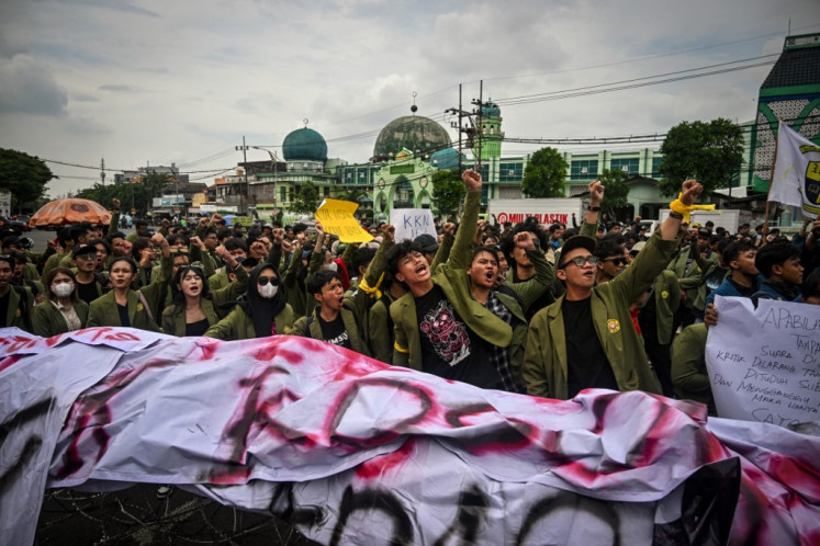 Students hold a rally titled Indonesia Gelap (Dark Indonesia) to oppose budget-cutting policies by President Prabowo Subianto in front of the East Java Regional House of Representatives building in Surabaya on Feb. 17, 2025.
