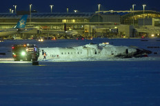 A Delta airlines plane sits on its roof after crashing upon landing at Toronto Pearson Airport in Toronto, Canada, on February 17, 2025. A Delta Air Lines jet with 80 people onboard crash landed Monday at the Toronto airport, officials said, flipping upside down and leaving at least 15 people injured but causing no fatalities. The Endeavor Air flight 4819 with 76 passengers and four crew was landing at around 3:30 pm in Canada's biggest metropolis, having flown from Minneapolis in the US state of Minnesota, the airline said.  