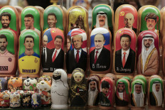 Traditional Russian wooden nesting dolls, Matryoshka dolls, depicting world leaders and celebrities are displayed for sale on Feb. 13 at a gift shop on tourist-oriented Arbat street in downtown Moscow.