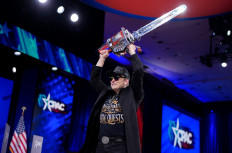 CEO of Tesla and SpaceX Elon Musk wields a chainsaw as he leaves the stage at the Conservative Political Action Conference (CPAC) at the Gaylord National Resort Hotel And Convention Center on February 20, 2025 in Oxon Hill, Maryland. 