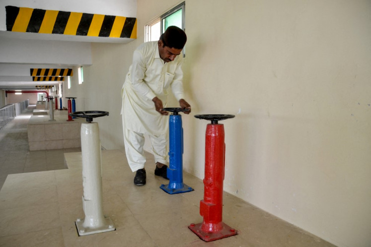 A technical staff works at the USAID-funded Pakistani non-profit HANDS water supply plant in Jacobabad in southern Sindh province, Pakistan on Feb. 18, 2025.