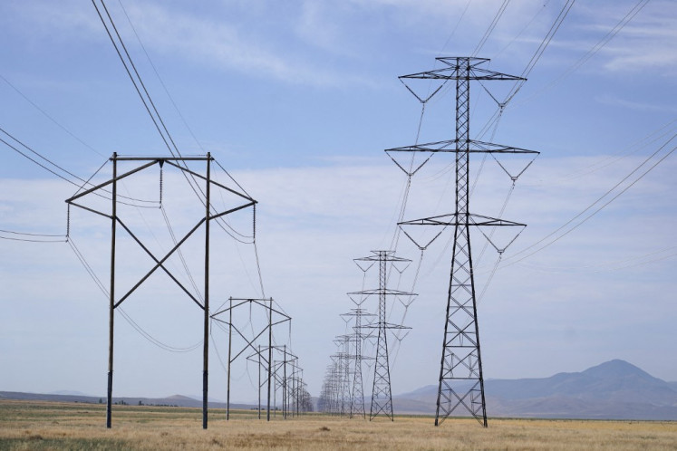 Electrical transmission lines are seen running through grassland to power the newly completed data center of Meta's Facebook, pictured in Eagle Mountain, Utah, the United States, on July 18, 2024.