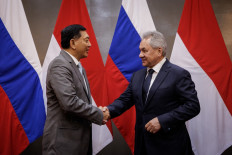 Russia's Security Council Secretary Sergei Shoigu (right), who served as Russia's Defence Minister between 2012 and 2024, and Indonesia's Defence Minister Sjafrie Sjamsoeddin shake hands as they exchange gifts after their bilateral meeting at the Defence Ministry in Jakarta on February 25, 2025. 