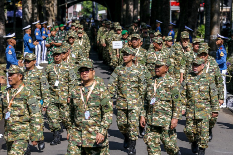 Newly installed regional heads march in formation on Feb. 27, 2025, during a weeklong glamping retreat at the Military Academy in Magelang, Central Java.