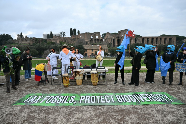 Environmental activists take part in a flash mob at Circo Massimo as the COP16 biodiversity conference resumes at the United Nations' Food and Agriculture Organization (FAO) headquarters in Rome, Italy on Feb. 25, 2025.