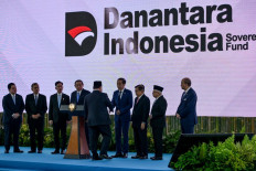 President Prabowo Subianto (center, back turned) shakes hands with his predecessor Joko “Jokowi“ Widodo on Feb. 24, 2025, during the launch of the Daya Anagata Nusantara (Danantara) sovereign wealth fund in Jakarta. 