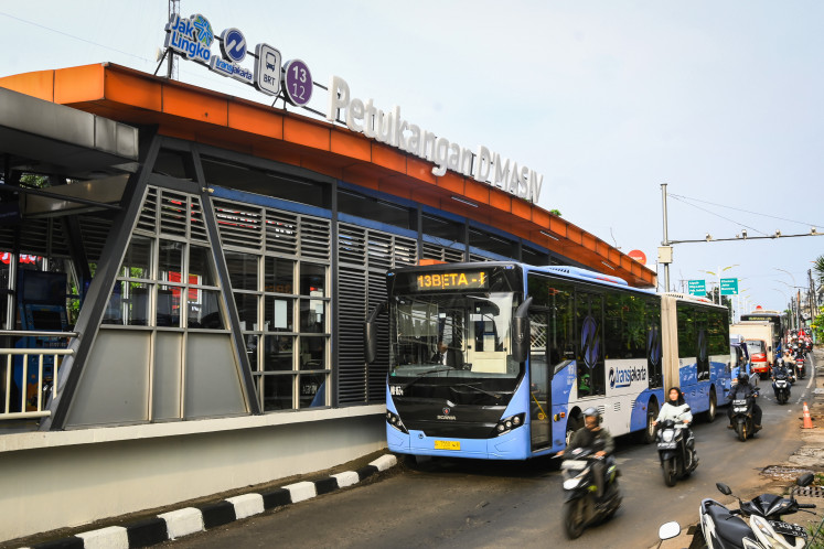 A Transjakarta bus stops at the Petukangan D'Masiv bus stop in Jakarta on March 3, 2025. PT Transjakarta has partnered with the band D'Masiv to rename the Petukangan bus stop to Petukangan D'Masiv to encourage more people to use public transportation.