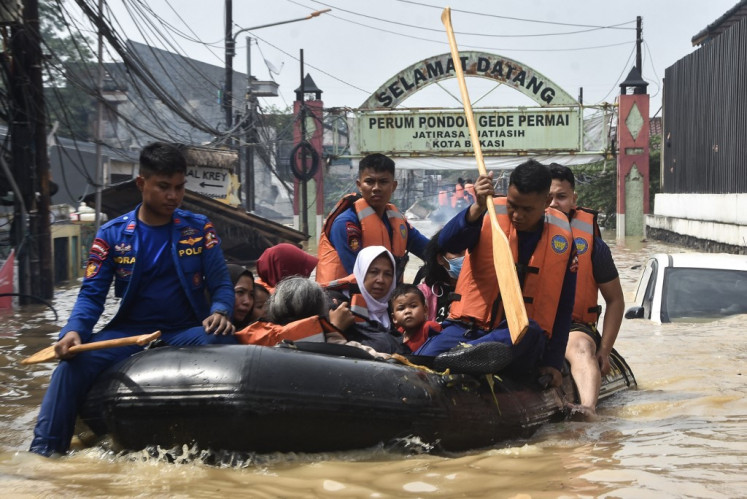 Search and rescue officers use a raft on March 4, 2025, as they evacuate people from the flooded Pondok Gede Permai Housing Complex in Bekasi, West Java.