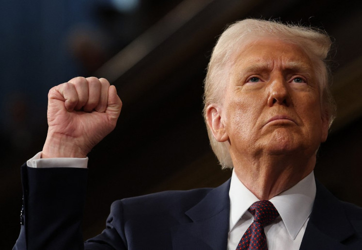 US President Donald Trump raises his fist as he addresses a joint session of Congress at the US Capitol in Washington, DC, on March 4, 2025. 