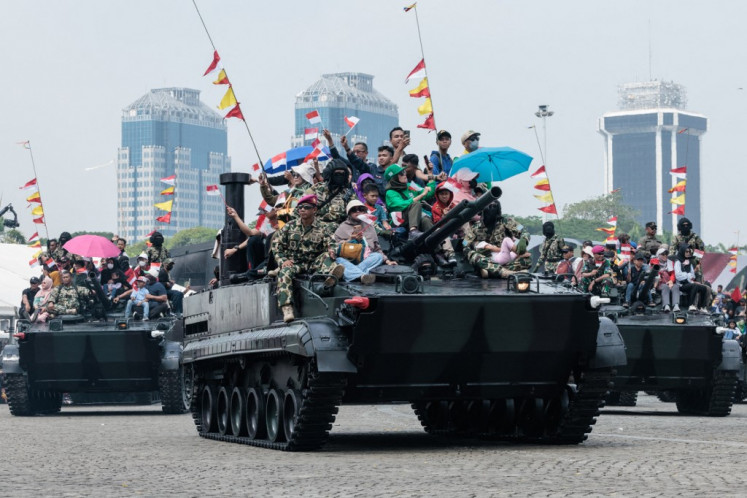 Prepared for the future?: People are seen on top of a military vehicle during a parade on Oct. 5, 2024, held as part of celebrations marking the 79th anniversary of the Indonesian Military (TNI) in front of the National Monument (Monas) at Merdeka Square in Jakarta.